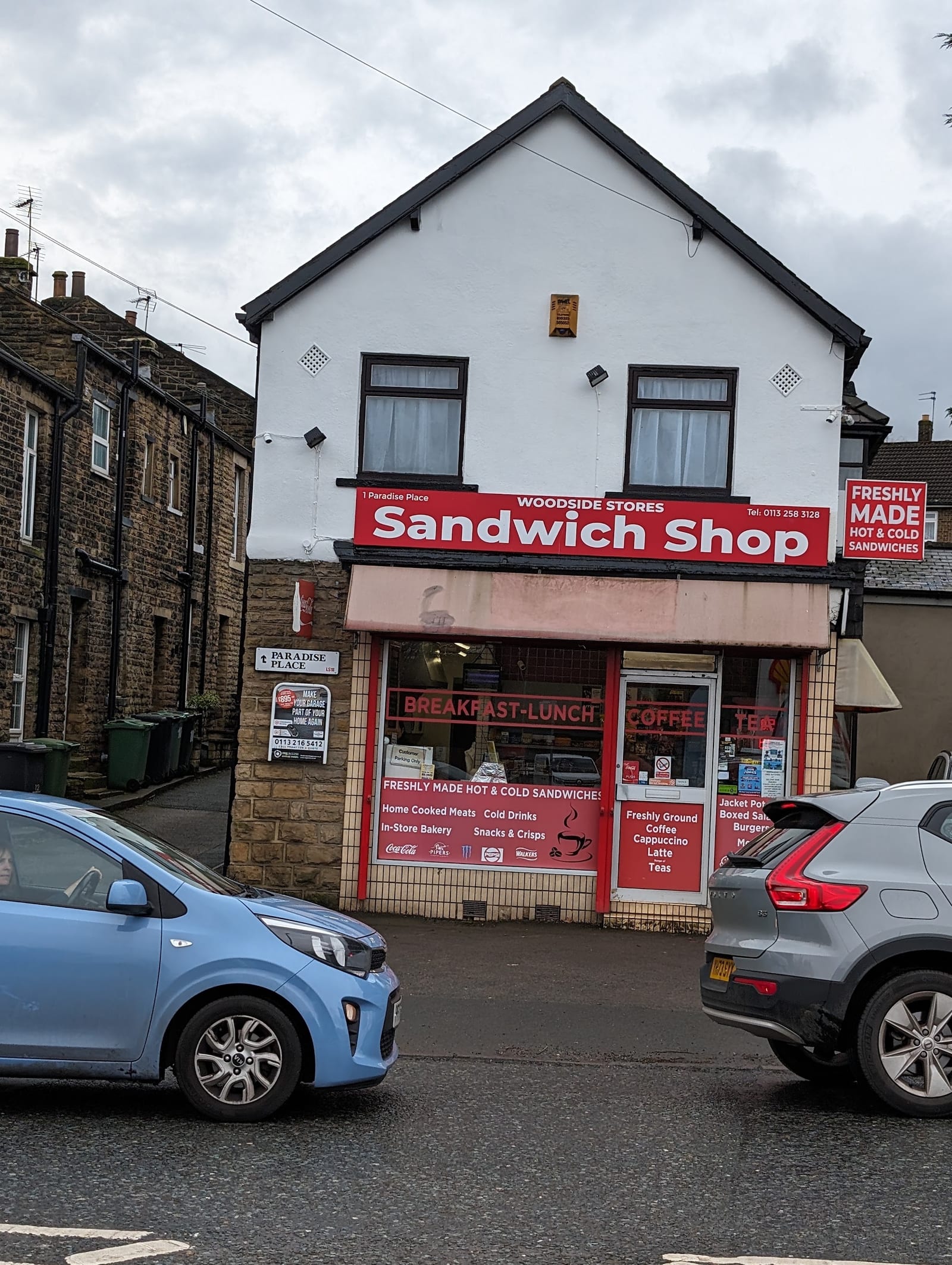 The red Woodside Stores Sandwich Shop fascia at 1 Paradise Place, Horsforth